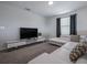Contemporary living room features modern furnishings, a stylish sofa, and a large screen TV at 4807 Kings Castle Cir, Kissimmee, FL 34746