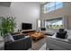 Bright living room with high ceilings, large windows, and modern decor at 4807 Kings Castle Cir, Kissimmee, FL 34746