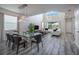 Bright, open-concept living room with a glass dining table and stylish furniture at 4807 Kings Castle Cir, Kissimmee, FL 34746
