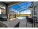 Covered patio area with comfortable seating and pond views at 4807 Kings Castle Cir, Kissimmee, FL 34746