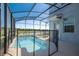 Screened pool with lake view and a surrounding fence for safety and protection at 4807 Kings Castle Cir, Kissimmee, FL 34746