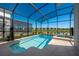 Sparkling screened-in pool and hot tub area with lush landscaping at 4807 Kings Castle Cir, Kissimmee, FL 34746