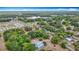 Expansive aerial view of a home with mature trees in a serene, partially wooded neighborhood at 511 E Mirror Lake Dr, Fruitland Park, FL 34731