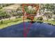 Stunning aerial view showcasing the property, serene lake, and verdant surroundings at 511 E Mirror Lake Dr, Fruitland Park, FL 34731