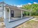 Spacious back porch with ample room for grilling and entertaining, perfect for outdoor gatherings and relaxation at 511 E Mirror Lake Dr, Fruitland Park, FL 34731