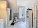 Well-lit bathroom featuring white fixtures, marble accents, and a window, providing a clean and relaxing environment at 511 E Mirror Lake Dr, Fruitland Park, FL 34731
