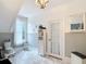 Bright bathroom with white fixtures, marble flooring, and ample natural light, creating a clean and inviting space at 511 E Mirror Lake Dr, Fruitland Park, FL 34731