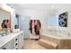 Bright bathroom featuring a soaking tub, double vanity, and decorative tile accents at 511 E Mirror Lake Dr, Fruitland Park, FL 34731