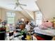 Cozy bedroom with a pitched ceiling, bright windows and comfortable furnishings, perfect for relaxation and rest at 511 E Mirror Lake Dr, Fruitland Park, FL 34731