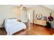 Bedroom with hardwood floors, natural light, and a view into an adjacent room at 511 E Mirror Lake Dr, Fruitland Park, FL 34731