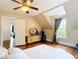 Bedroom features hardwood floors, neutral colors, and a view into an adjacent room at 511 E Mirror Lake Dr, Fruitland Park, FL 34731