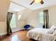 Bedroom features hardwood floors, natural light, and neutral colors with a vaulted ceiling at 511 E Mirror Lake Dr, Fruitland Park, FL 34731