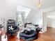 Bedroom features wood floors, natural light, neutral colors, and a crystal chandelier at 511 E Mirror Lake Dr, Fruitland Park, FL 34731