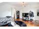 Bright bedroom featuring hardwood floors, white walls, and modern decor, creating a comfortable living space at 511 E Mirror Lake Dr, Fruitland Park, FL 34731