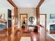 Foyer features wood columns, hardwood floors, and detailed millwork between rooms at 511 E Mirror Lake Dr, Fruitland Park, FL 34731