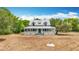 Front exterior view of a house featuring a charming wrap-around porch and well-maintained lawn at 511 E Mirror Lake Dr, Fruitland Park, FL 34731