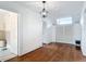 Upstairs hallway featuring hardwood floors, ample closet space, and natural light at 511 E Mirror Lake Dr, Fruitland Park, FL 34731