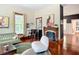 Inviting living room showcasing hardwood floors, vintage decor, and a cozy fireplace at 511 E Mirror Lake Dr, Fruitland Park, FL 34731