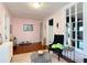 Cozy living room with pink walls, wood floors, and a decorative tin ceiling for vintage charm at 511 E Mirror Lake Dr, Fruitland Park, FL 34731