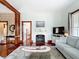 Bright living room featuring hardwood floors, a decorative fireplace, and neutral-toned furniture at 511 E Mirror Lake Dr, Fruitland Park, FL 34731