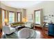 Cozy living room featuring hardwood floors, vintage furniture, and a round area rug at 511 E Mirror Lake Dr, Fruitland Park, FL 34731