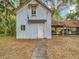 Exterior of outbuilding, featuring a small American flag and covered parking for multiple vehicles at 511 E Mirror Lake Dr, Fruitland Park, FL 34731