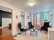 Bright sitting room with eclectic decor, a textured ceiling, and views to the outside at 511 E Mirror Lake Dr, Fruitland Park, FL 34731