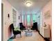 Bright sitting room with eclectic decor, a textured ceiling, and views to the outside at 511 E Mirror Lake Dr, Fruitland Park, FL 34731