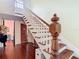 Elegant staircase featuring hardwood steps, white railings, and an open design at 511 E Mirror Lake Dr, Fruitland Park, FL 34731