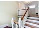 Wooden staircase featuring white railings and natural light from a nearby window at 511 E Mirror Lake Dr, Fruitland Park, FL 34731