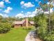 Aerial view of home on acreage surrounded by woods at 5180 Garlanger Trl, Oviedo, FL 32765