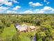 Stunning aerial view of private estate home surrounded by lush landscaping at 5180 Garlanger Trl, Oviedo, FL 32765