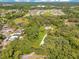 Sprawling estate nestled among towering trees, expansive lawns, and scenic pond views at 5180 Garlanger Trl, Oviedo, FL 32765