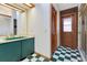 Bathroom with green and white tiled floor and shower at 5180 Garlanger Trl, Oviedo, FL 32765