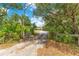 Long private driveway leading to a secluded home surrounded by mature trees at 5180 Garlanger Trl, Oviedo, FL 32765