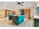 Open kitchen with stainless steel appliances, center island and view to outside at 5180 Garlanger Trl, Oviedo, FL 32765