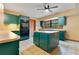 Bright kitchen featuring dark green cabinetry and tiled floors at 5180 Garlanger Trl, Oviedo, FL 32765