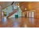 Spacious living room featuring wooden ceilings, tile floors, a wooden staircase, and french doors at 5180 Garlanger Trl, Oviedo, FL 32765
