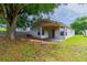Spacious backyard with a covered patio and plenty of shade from mature trees at 5423 Blueberry Dr, Orlando, FL 32811