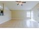 Bright living space with tile flooring, ceiling fan, and sliding glass door access to the backyard at 5423 Blueberry Dr, Orlando, FL 32811
