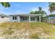 Backyard with covered patio and expansive grassy area offers room for recreation at 5438 Brownell St, Orlando, FL 32810