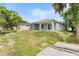 Backyard showcasing a spacious lot, mature trees, and a covered patio at 5438 Brownell St, Orlando, FL 32810