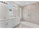 Modern bathroom with dual sinks, vanity, and tiled shower at 5438 Brownell St, Orlando, FL 32810