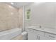 Bathroom features a tiled shower-tub combo, modern vanity, and fixtures at 5438 Brownell St, Orlando, FL 32810