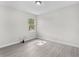 Bright bedroom with natural light, showcasing modern flooring and neutral paint at 5438 Brownell St, Orlando, FL 32810