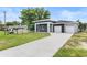 Contemporary home with a spacious driveway and a well-manicured lawn at 5438 Brownell St, Orlando, FL 32810