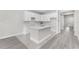 Modern kitchen featuring white cabinets, an island, and updated countertops at 5438 Brownell St, Orlando, FL 32810