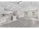 Open-concept living room and kitchen area with recessed lighting and wood flooring at 5438 Brownell St, Orlando, FL 32810