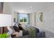 Comfortable main bedroom features plush bedding and a view to the outside at 548 Zinfandel Dr, Daytona Beach, FL 32117