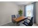 Modern office space with a wooden desk, bright window, and modern chairs at 548 Zinfandel Dr, Daytona Beach, FL 32117